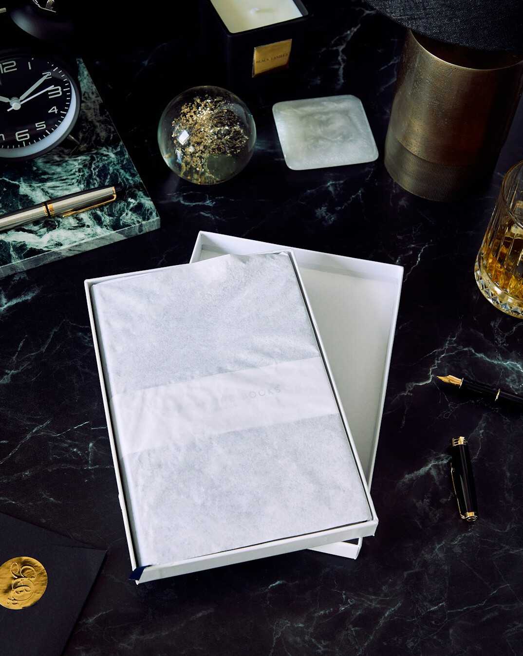 Pen writing in a notebook on a wooden desk