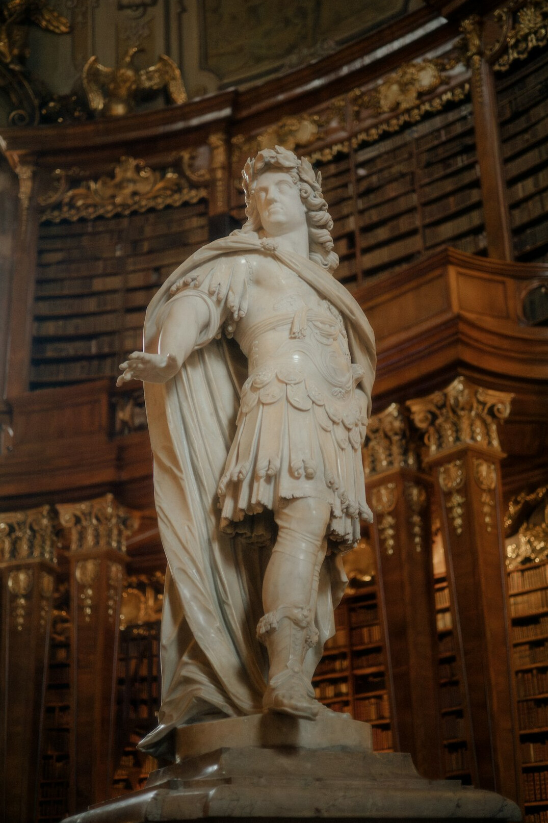 Grand ornate library hall with rows of bookshelves