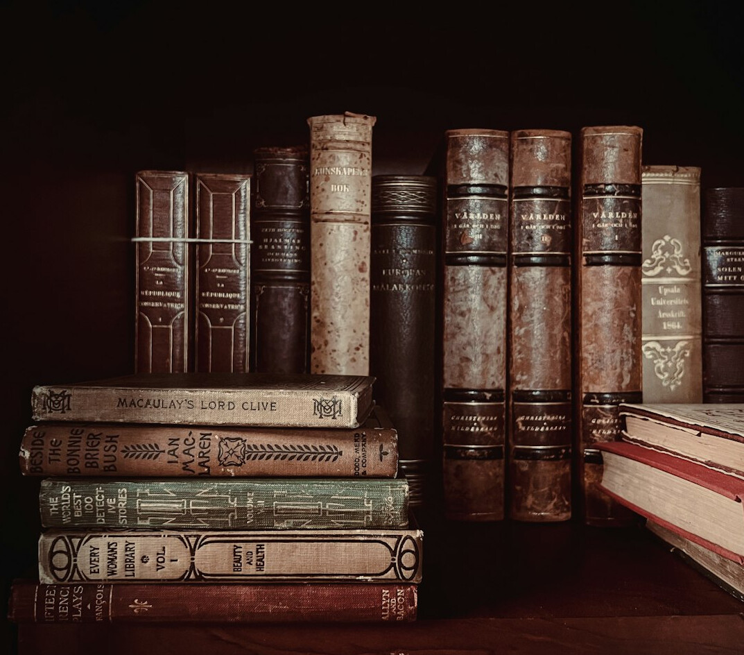 Stack of old vintage books with worn covers